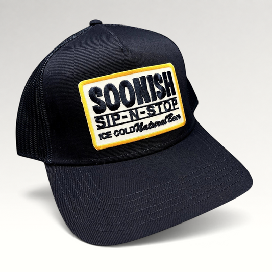 Raree Finds navy blue Otto trucker hat with an embroidered Soonish Sip-N-Stop Ice Cold Natural Beer patch