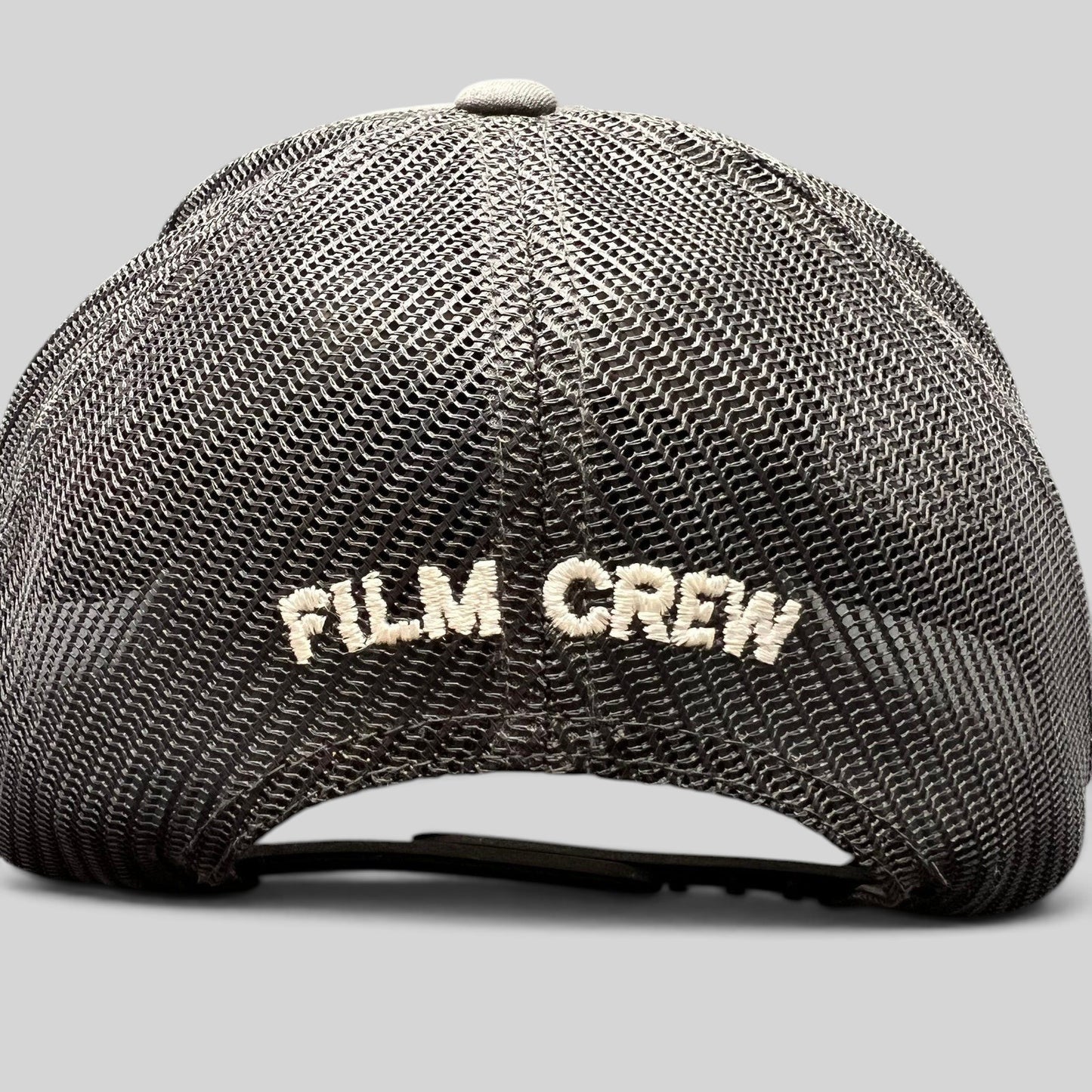 Raree Finds NCIS Hawaii film crew trucker hat with white FILM CREW embroidery on a black mesh back panel