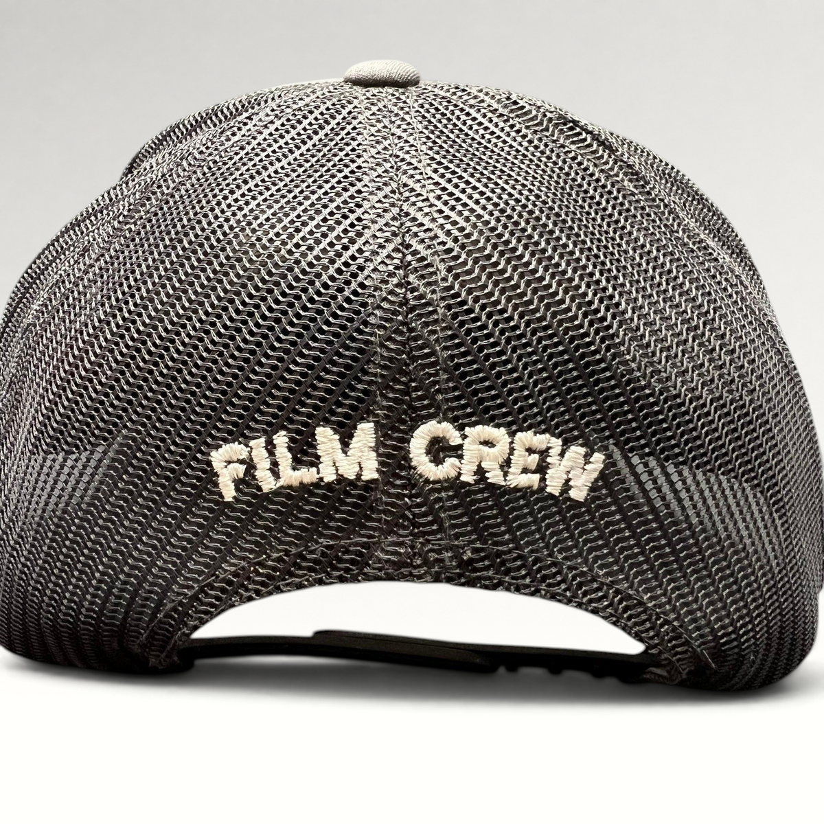 Raree Finds NCIS Hawaii film crew trucker hat with white FILM CREW embroidery on a black mesh back panel
