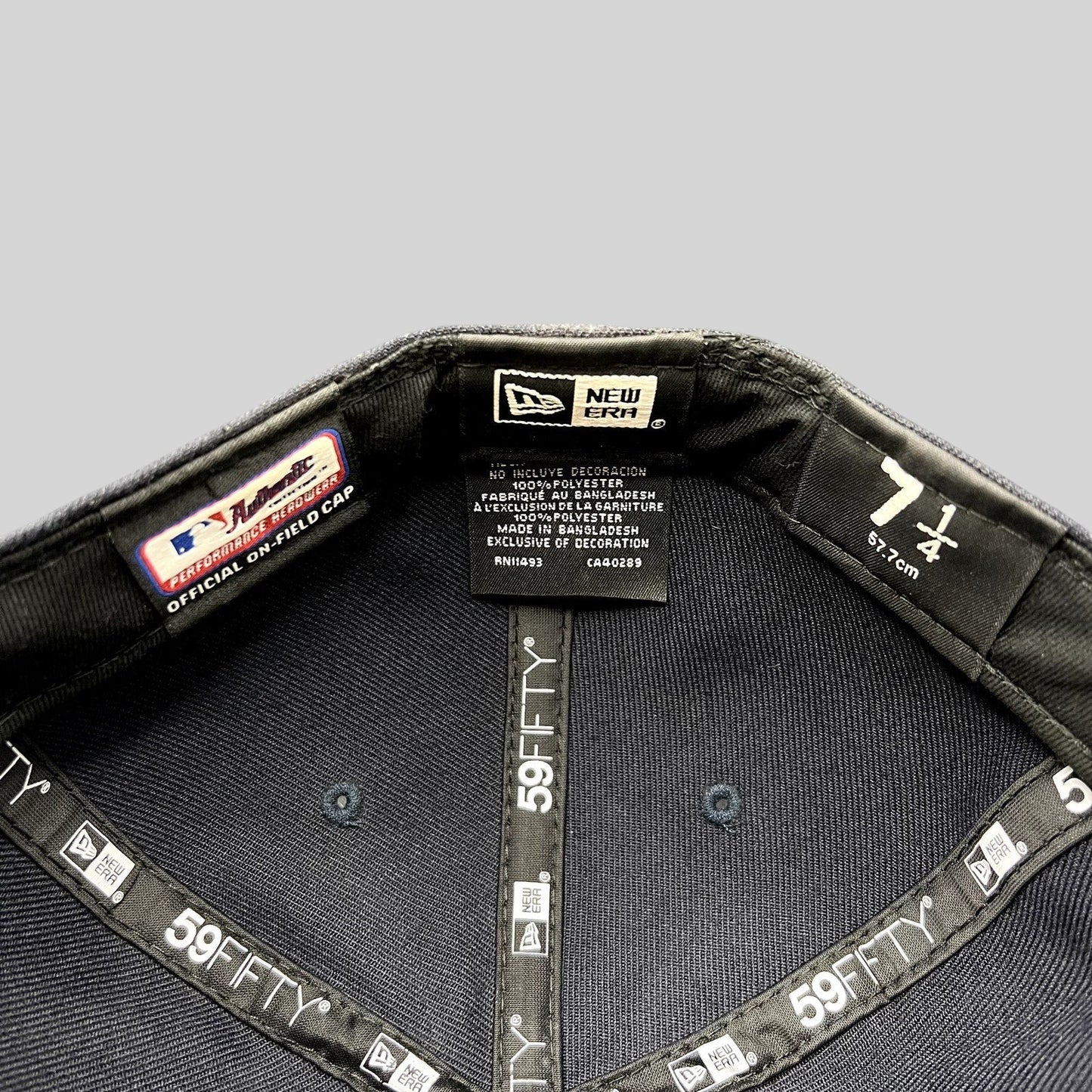 Interior of a Raree Finds New Era 59FIFTY fitted hat showing size 7 1/4 label and official performance taping