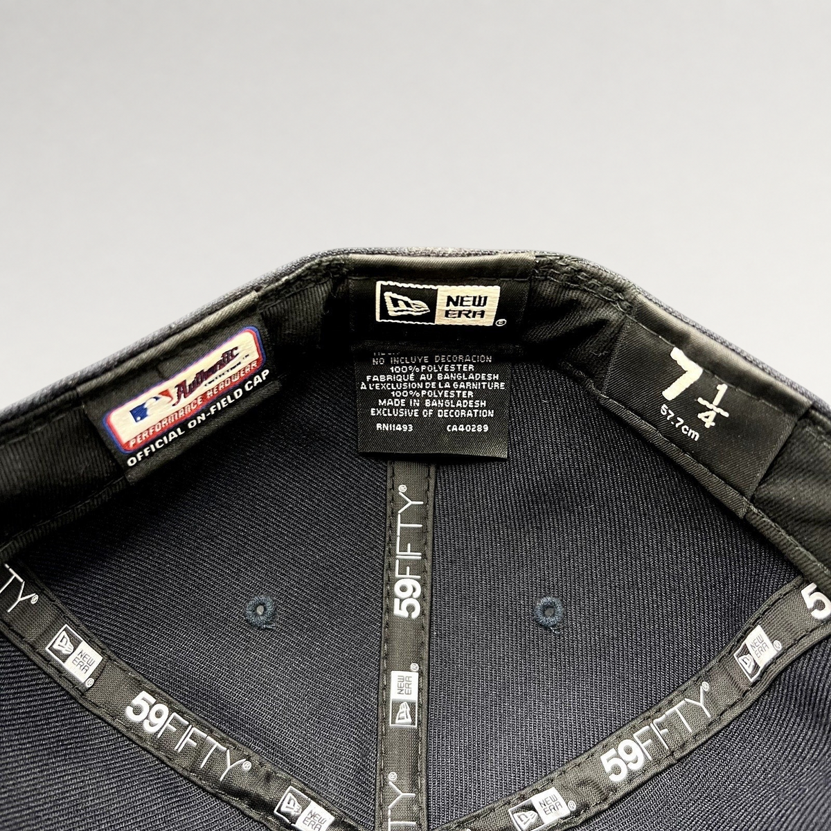 Interior of a Raree Finds New Era 59FIFTY fitted hat showing size 7 1/4 label and official performance taping