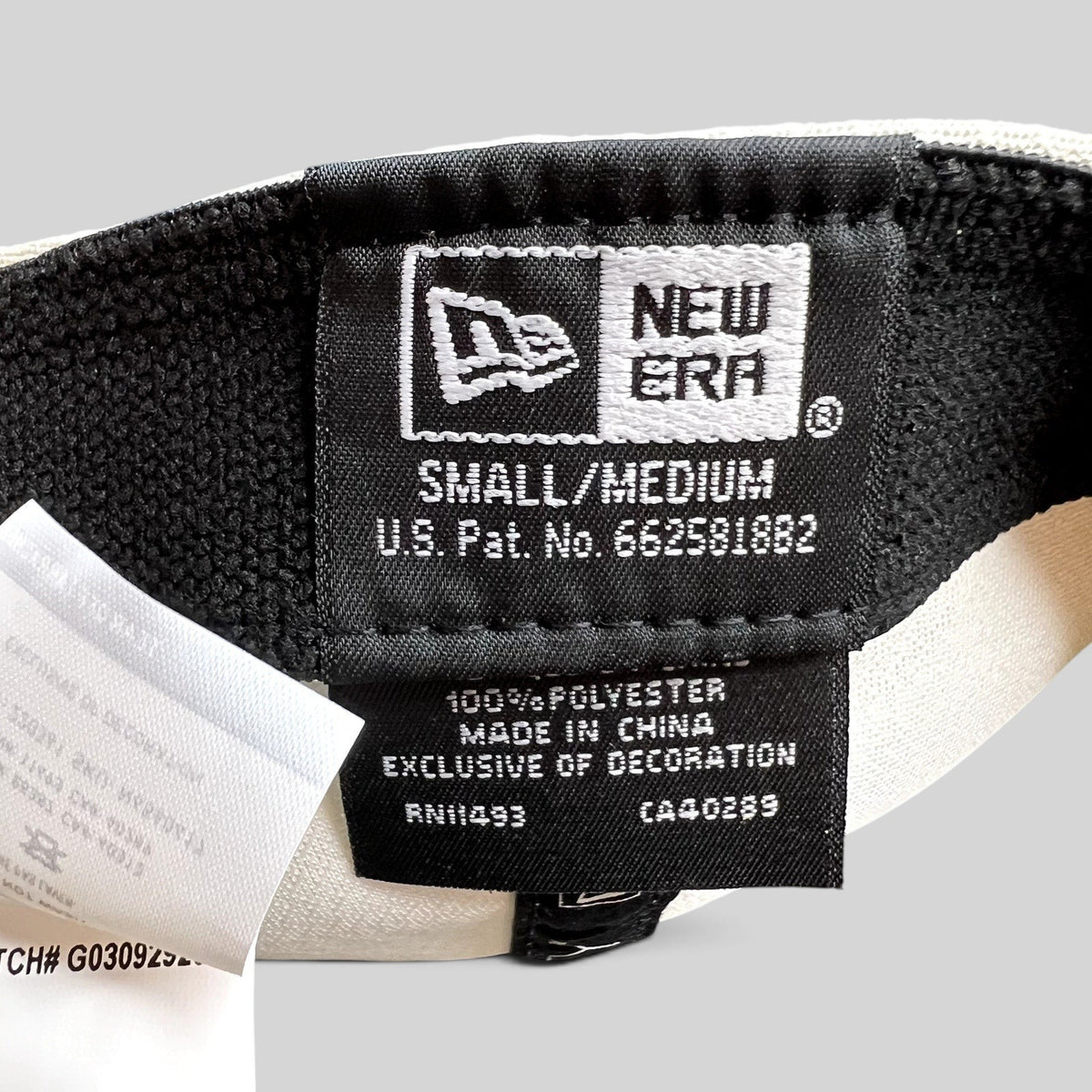 Raree Finds New Era 39THIRTY golf hat interior label showing size small medium and polyester material details