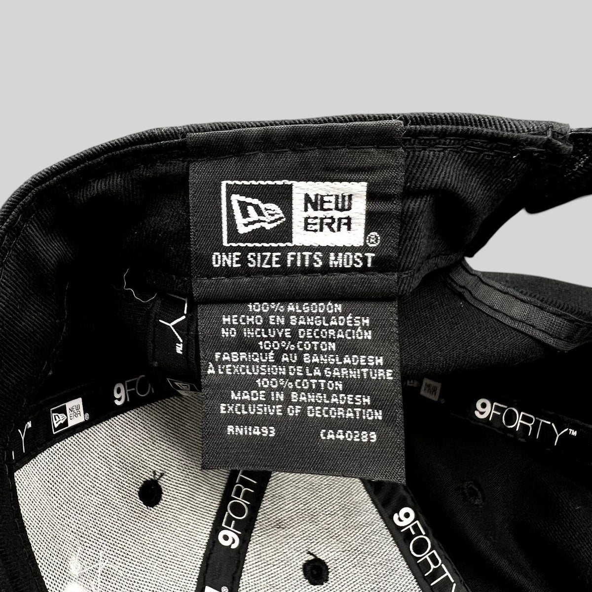 Raree Finds black New Era 9FORTY hat interior showing cotton care label and branding tags