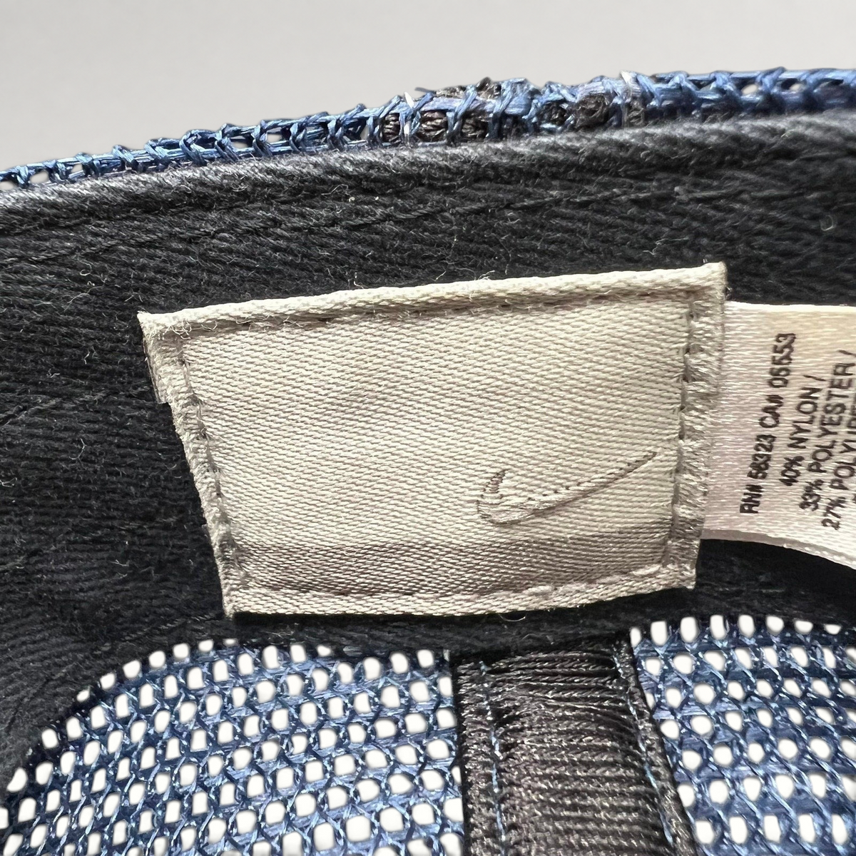 Raree Finds vintage Nike trucker hat interior tag with swoosh logo and fabric composition details
