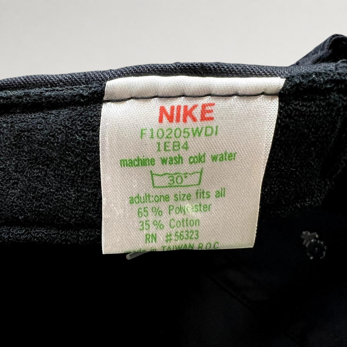 Raree Finds vintage Nike hat care tag showing 65 percent polyester and 35 percent cotton blend made in Taiwan