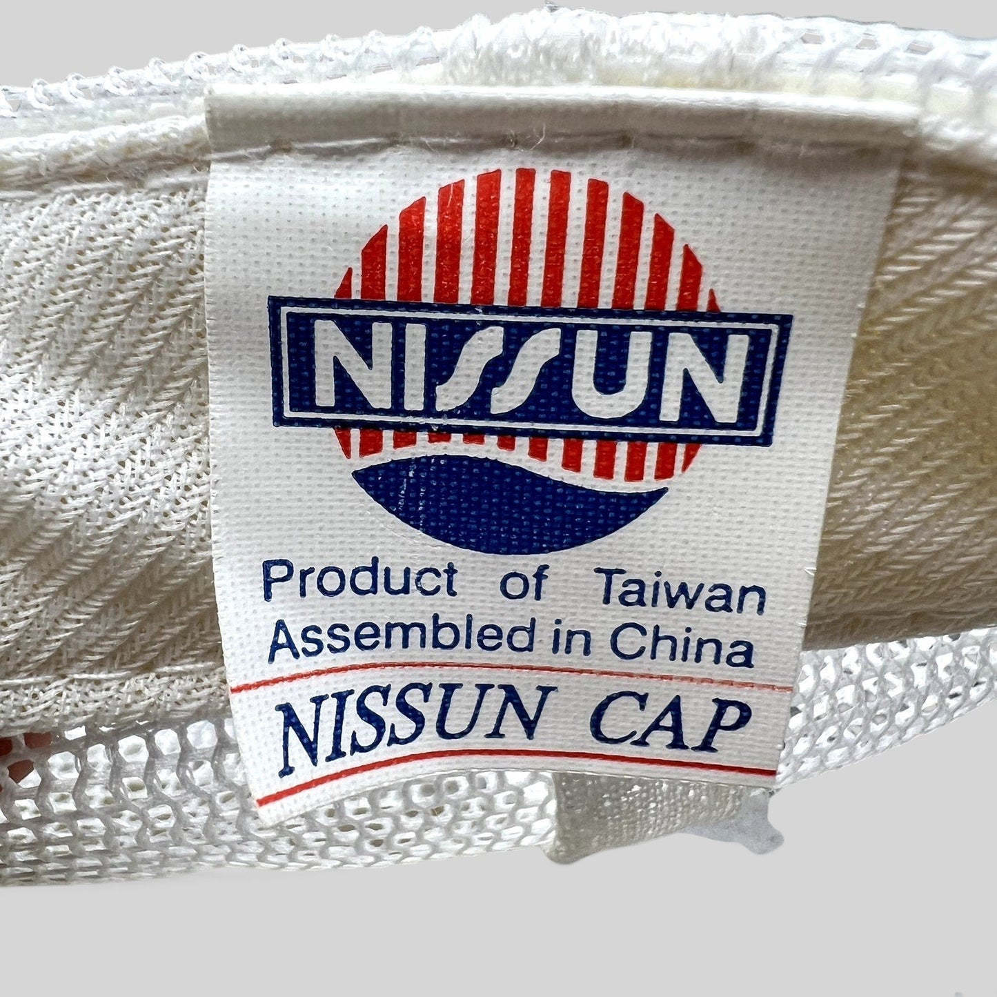 Raree Finds vintage Nissun Cap label inside a white Rockstar Energy Drink trucker hat with mesh detailing
