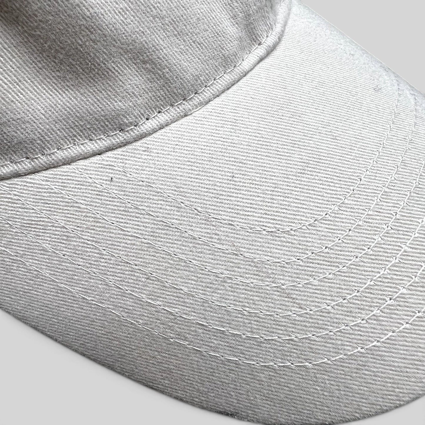 Raree Finds off-white cotton strapback hat with detailed stitching on the curved brim from Land of the Lost movie