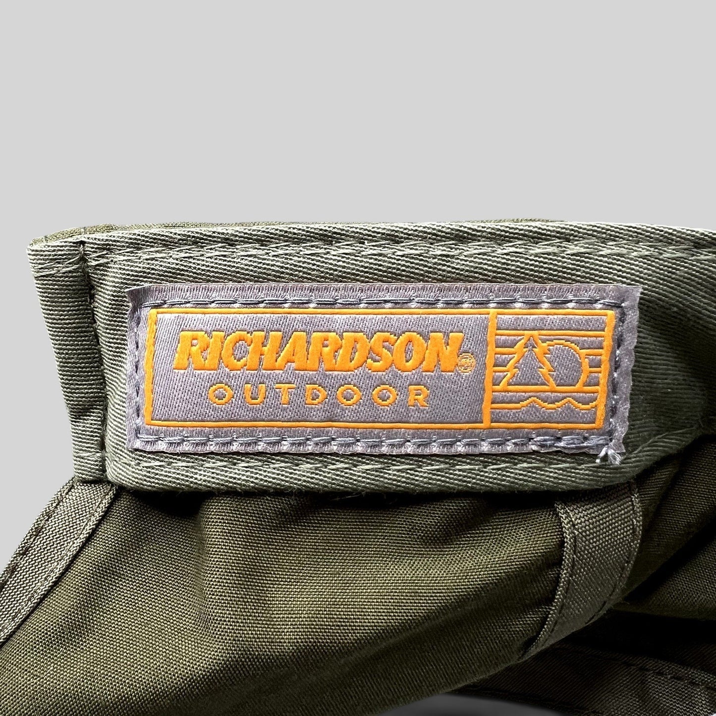 Raree Finds olive green Richardson Outdoor cap interior label with orange branding and performance fabric detail