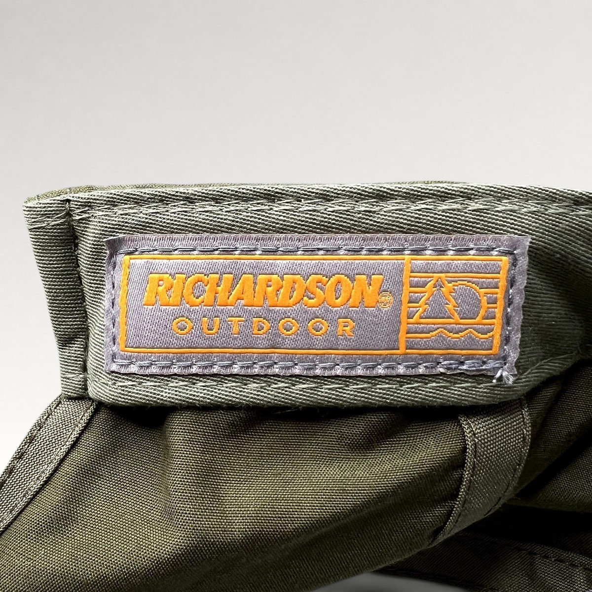 Raree Finds olive green Richardson Outdoor cap interior label with orange branding and performance fabric detail