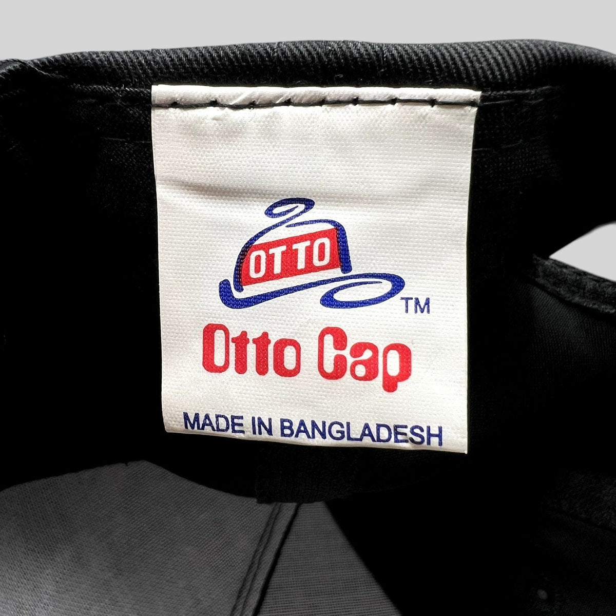 Raree Finds vintage Otto Cap brand label inside a black snapback hat made in Bangladesh