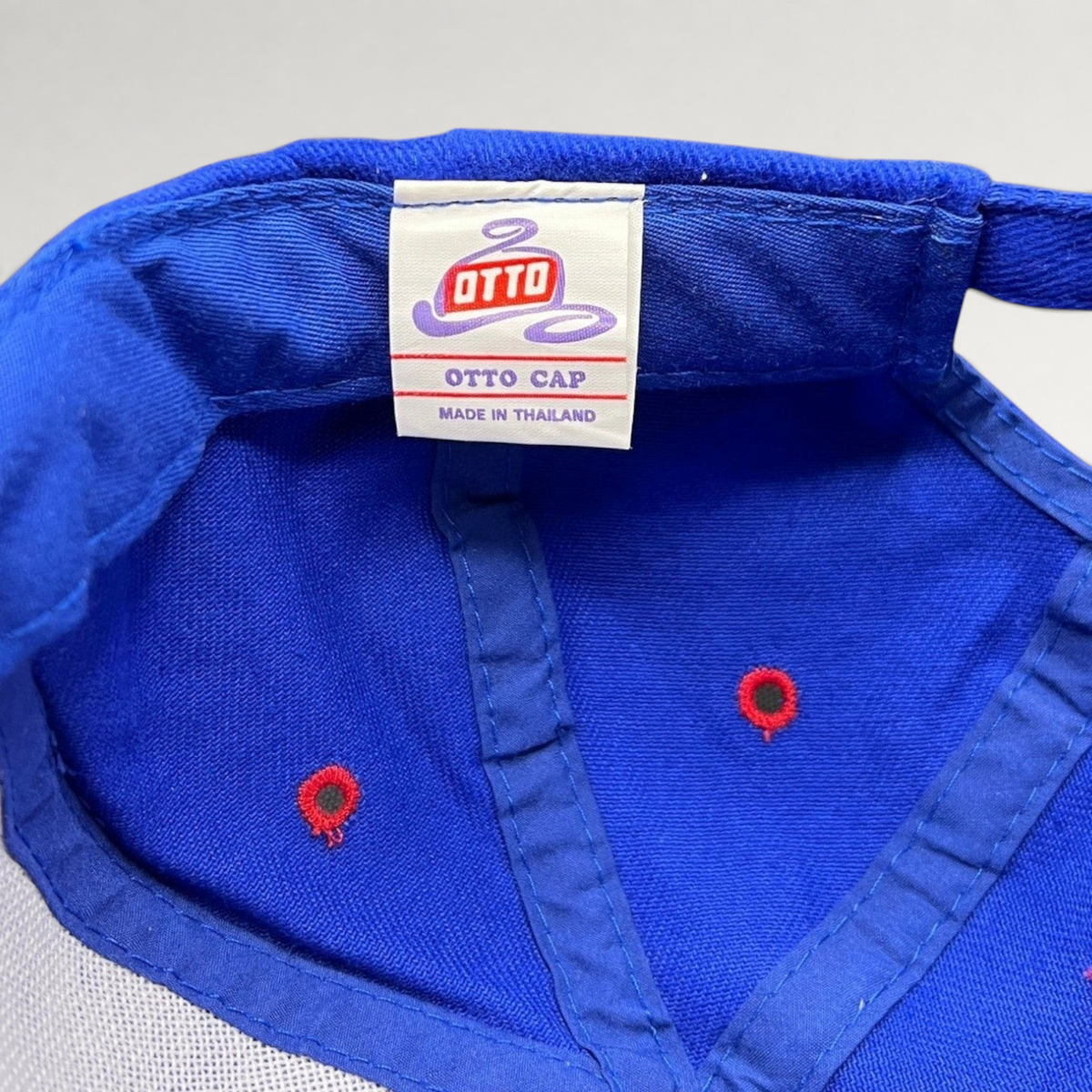 Raree Finds vintage 90s Otto Cap snapback hat interior label showing royal blue fabric and red ventilation eyelets
