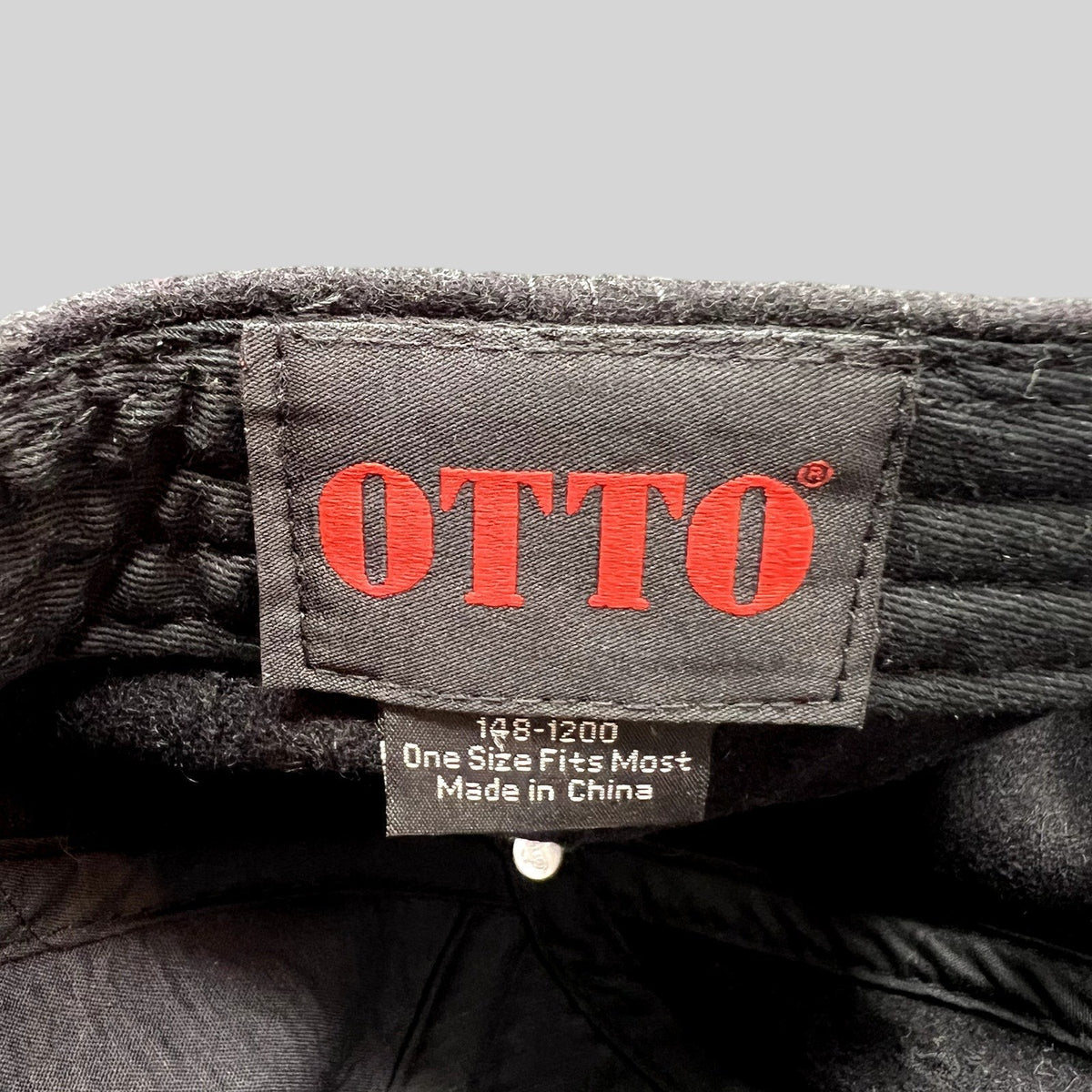 Raree Finds Otto brand label inside a black wool blend Ikon Pass strapback hat with size and origin information.
