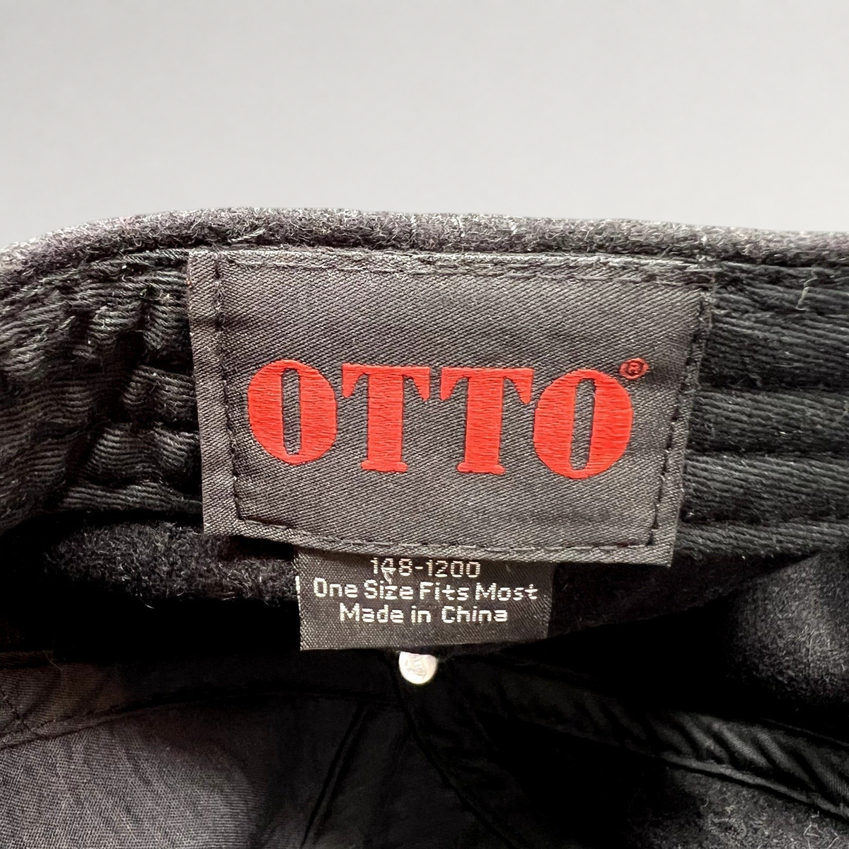 Raree Finds black Otto wool-blend hat interior label showing brand logo and manufacturing details