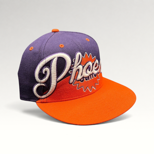 Raree Finds Phoenix Suns Hardwood Classics snapback hat with purple crown, orange brim, and embroidered script logo.