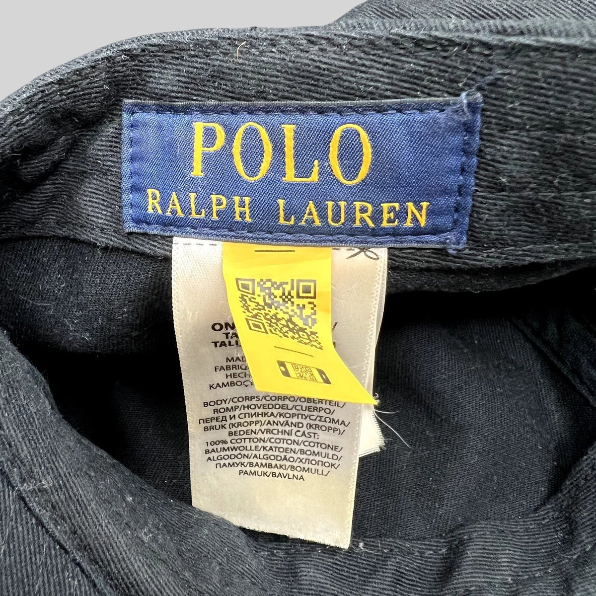 Raree Finds Polo Ralph Lauren hat interior tag with blue brand label, care instructions, and yellow QR code tag.