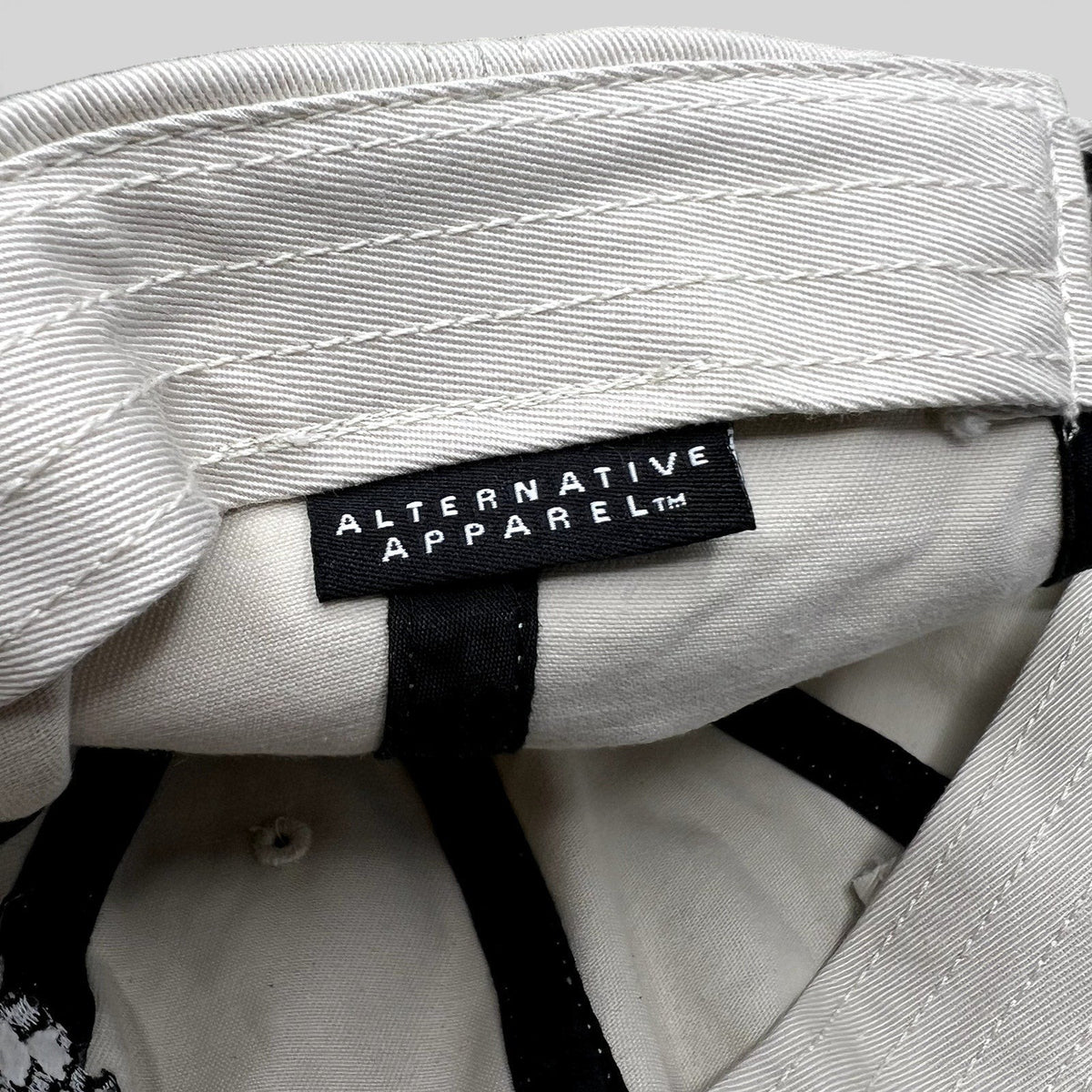 Raree Finds Porsche Driving Experience hat interior featuring an Alternative Apparel brand label on cream fabric