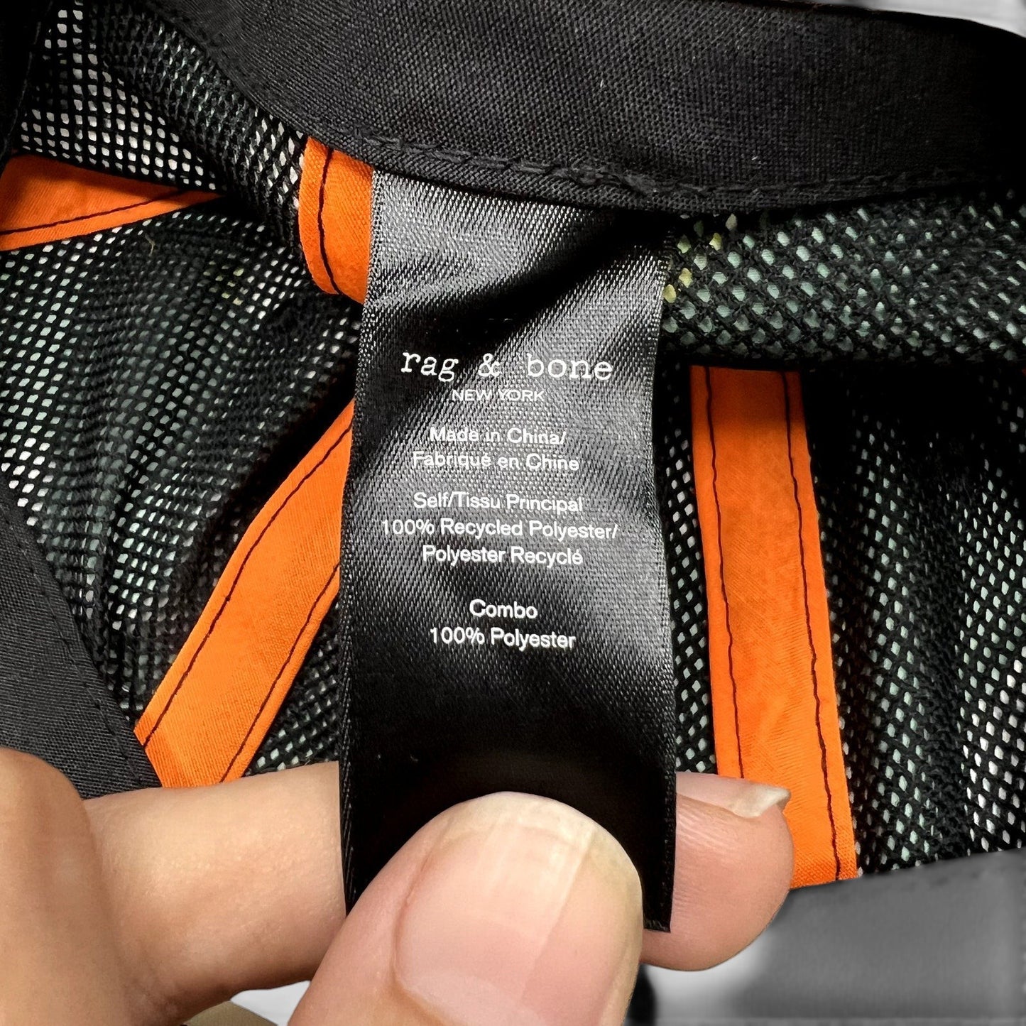 Raree Finds Rag & Bone New York cap interior tag showing 100% recycled polyester material and mesh lining details