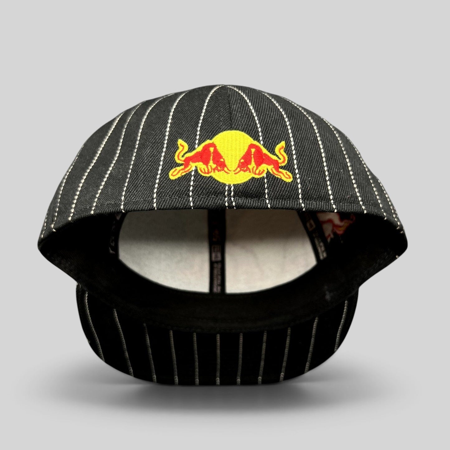 Raree Finds black and white pinstripe New Era 59FIFTY fitted hat with embroidered Red Bull logo on the front