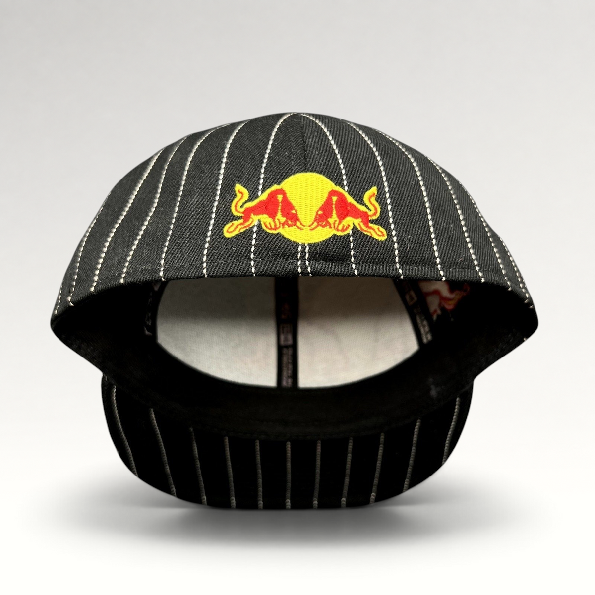 Raree Finds black and white pinstripe New Era 59FIFTY fitted hat with embroidered Red Bull logo on the front
