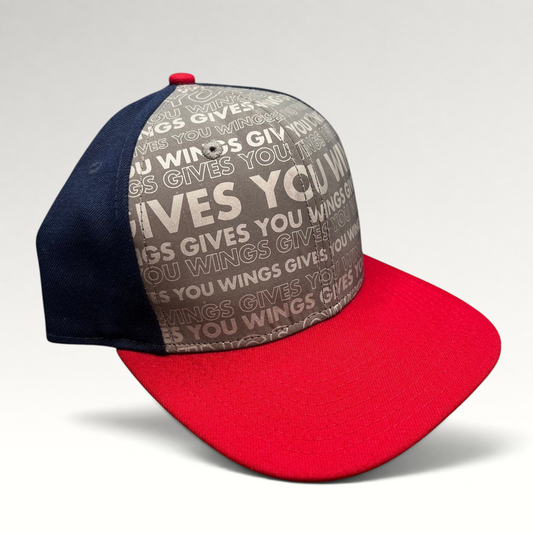 Raree Finds New Era Red Bull snapback hat with grey Gives You Wings text pattern, navy panels, and a red brim.