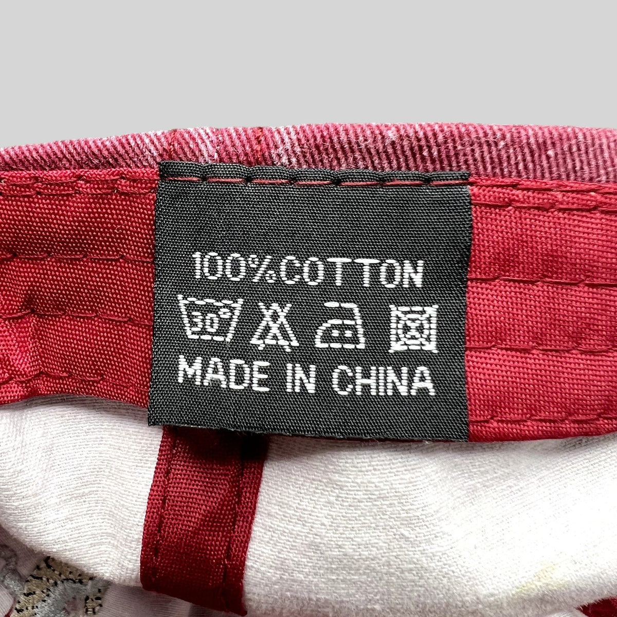 Raree Finds vintage red cotton hat interior care label showing 100% cotton material and laundry instructions