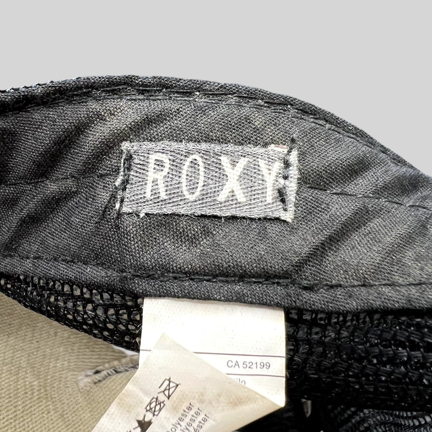 Raree Finds Roxy trucker hat interior label showing brand logo and care tag details on black mesh fabric