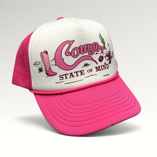 Raree Finds Shyanne pink and white trucker hat with Cowgirl State of Mind graphic, cowboy boots, and desert artwork.
