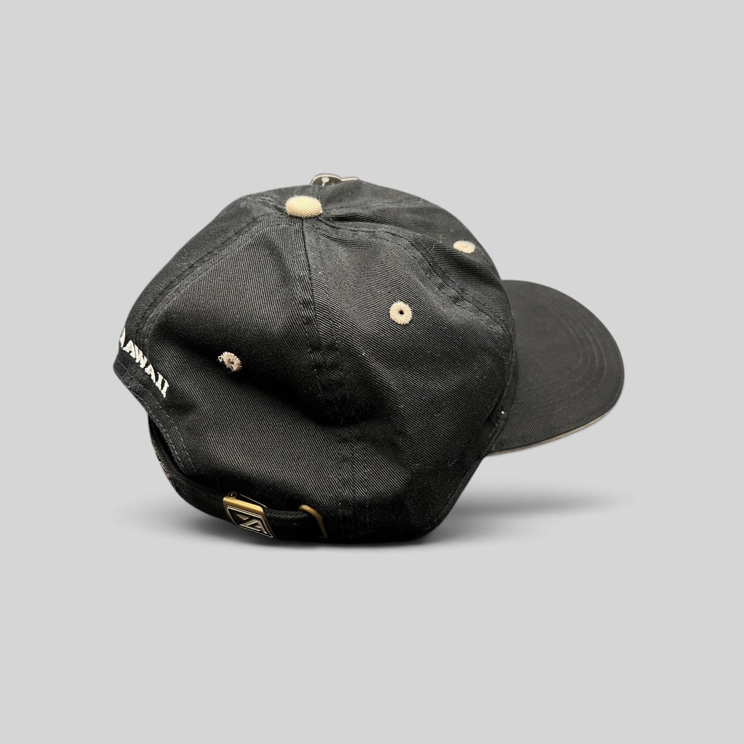 Raree Finds Sony Open Hawaii golf hat in black cotton with beige eyelets and brass buckle strapback