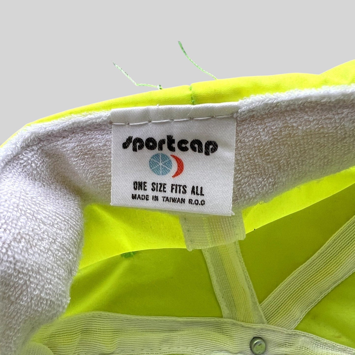 Raree Finds vintage Sportcap neon yellow nylon hat interior label showing manufacturing details and origin