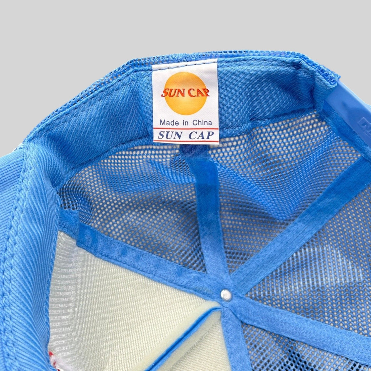 Raree Finds light-blue Sun Cap trucker hat interior showing brand label and mesh construction