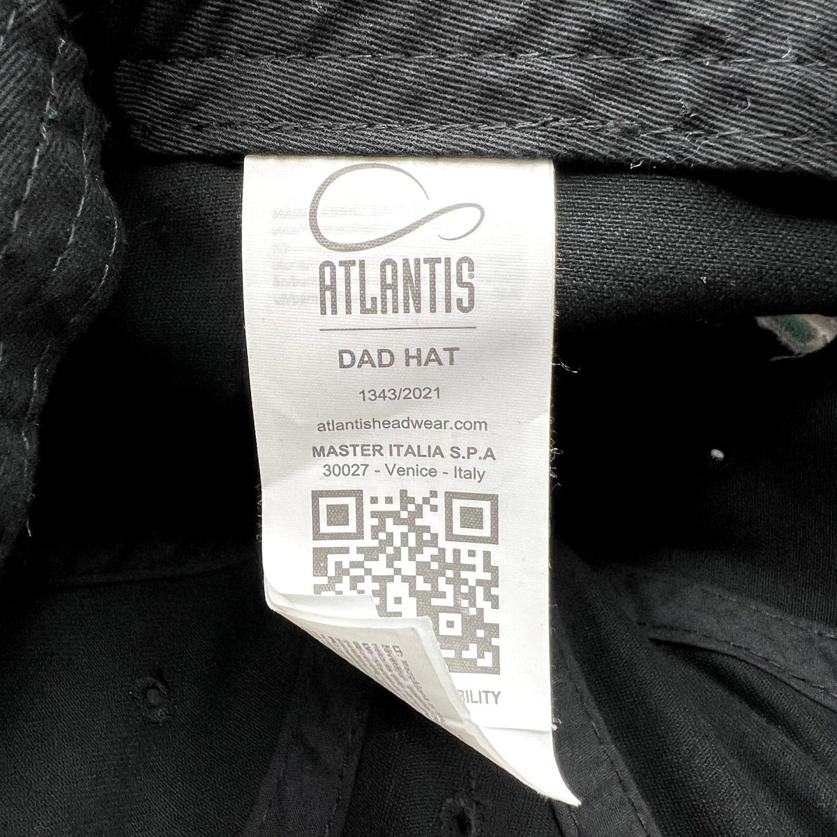 Raree Finds TikTok promotional hat interior care label by Atlantis Headwear featuring a QR code and brand details
