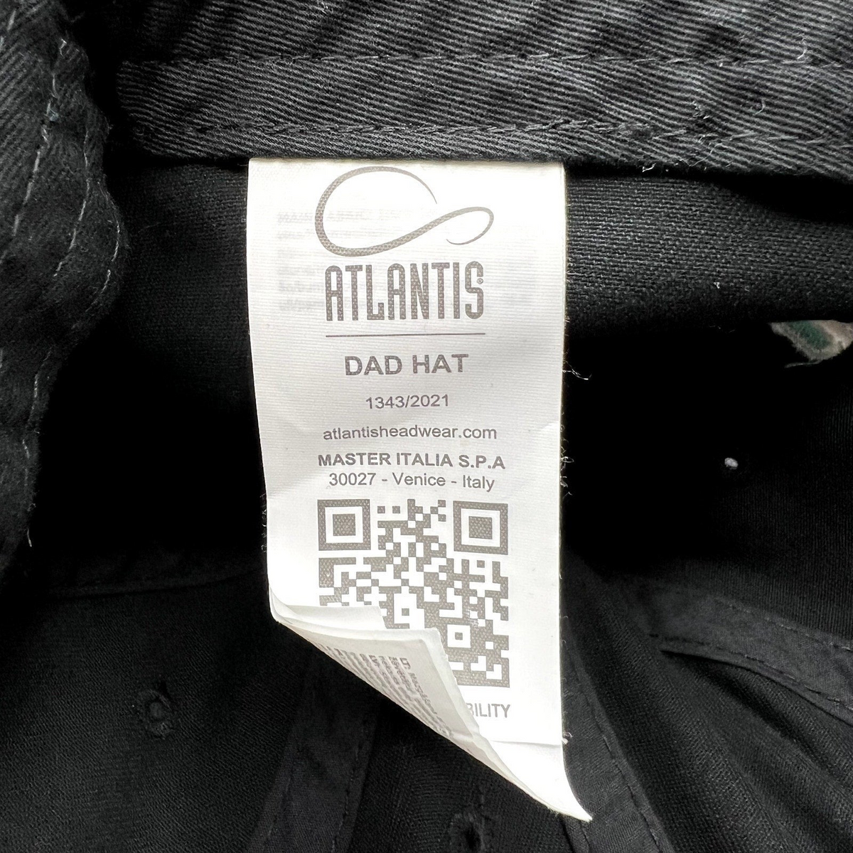 Raree Finds TikTok promotional hat interior care label by Atlantis Headwear featuring a QR code and brand details