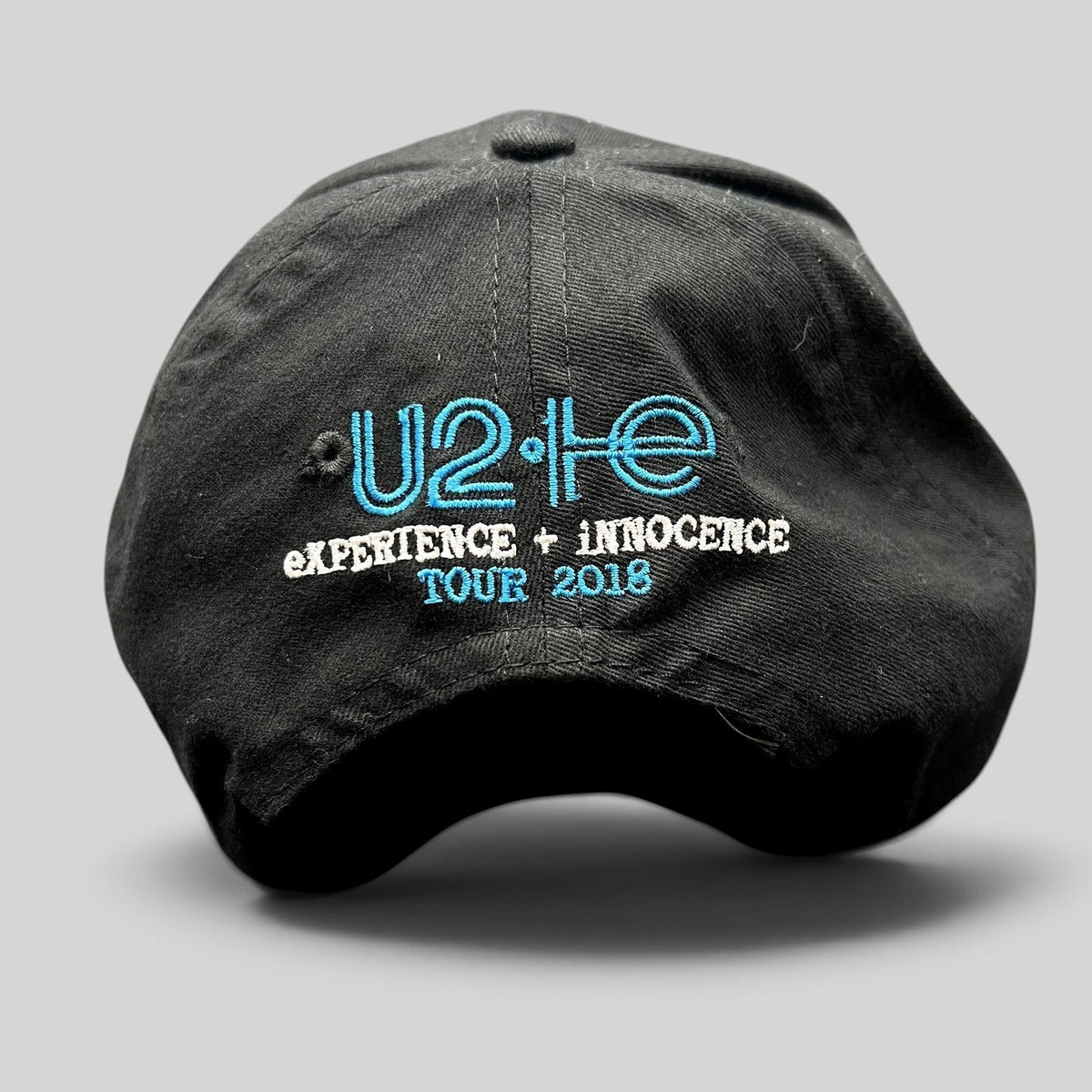 Raree Finds black U2 eXPERIENCE + iNNOCENCE Tour 2018 strapback hat with blue and white embroidered rear logo