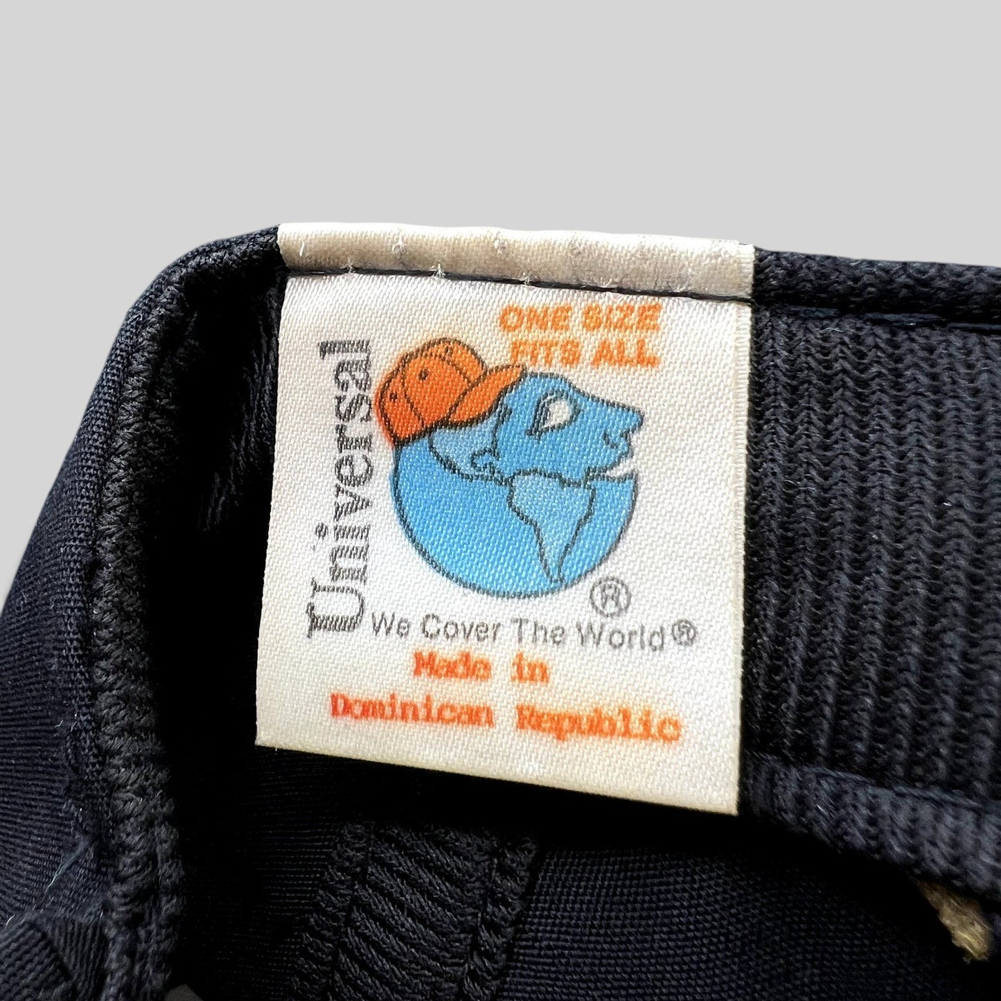 Raree Finds vintage Universal Industries hat interior tag showing globe logo and Made in Dominican Republic text