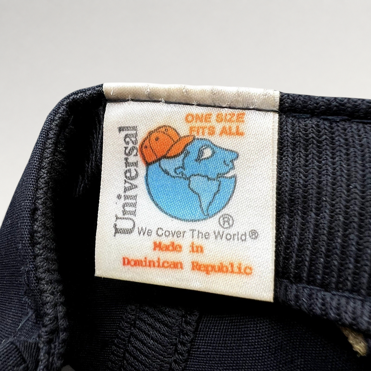 Raree Finds vintage Universal Industries hat tag showing Made in Dominican Republic and One Size Fits All text