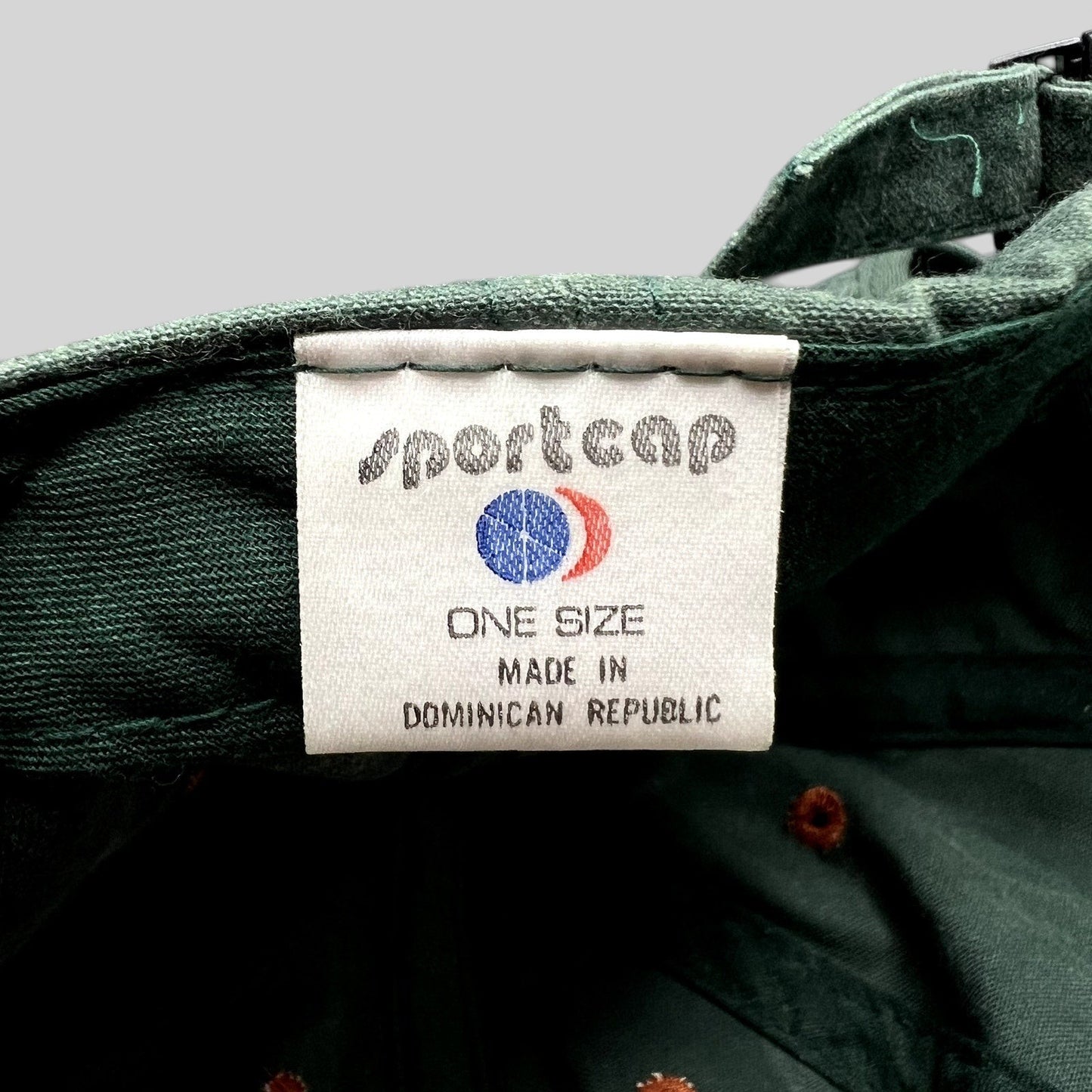 Raree Finds vintage green strapback fishing hat interior label showing Sportcap branding and origin details