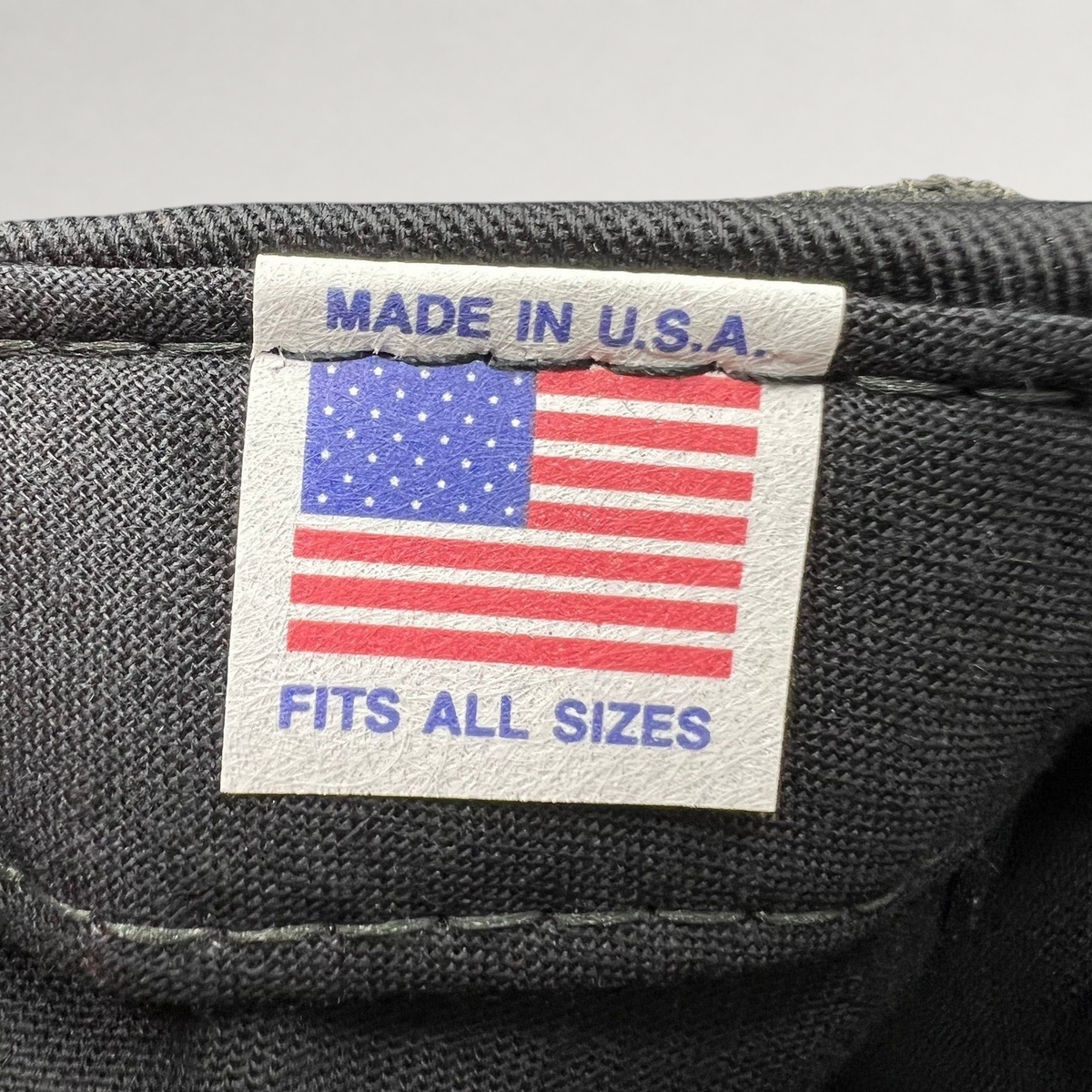 Raree Finds vintage hat interior tag featuring an American flag graphic with Made in U.S.A. and Fits All Sizes text.
