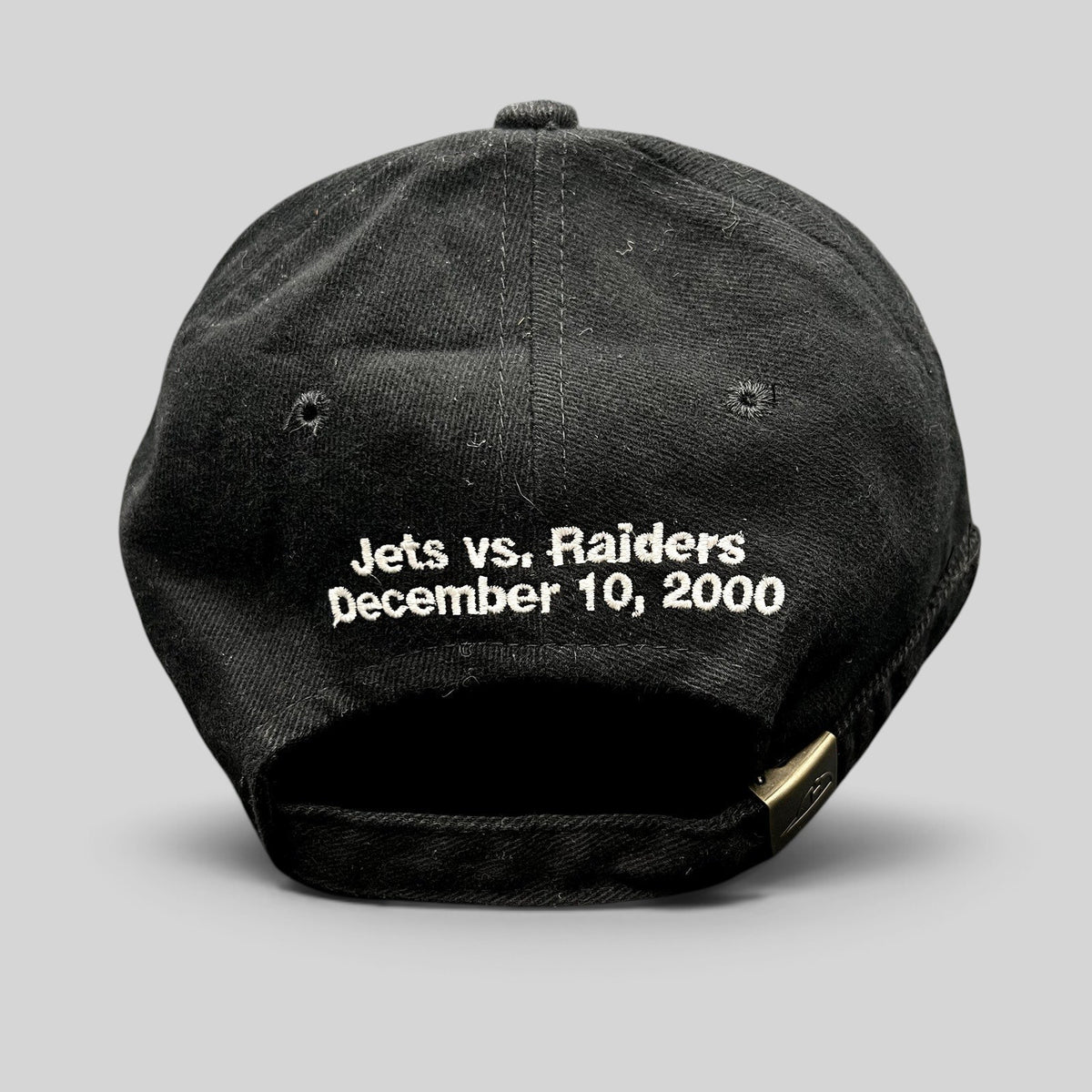 Raree Finds vintage black cotton strapback hat with Jets vs Raiders December 10 2000 embroidery on the back