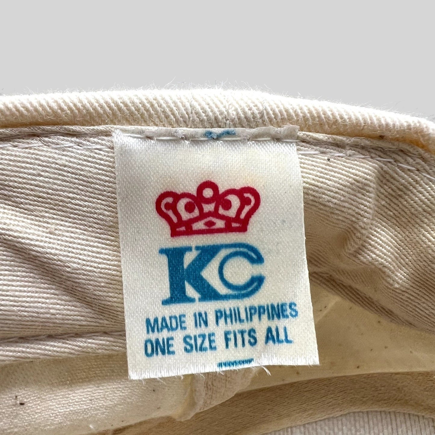 Raree Finds vintage KC cap interior label showing crown logo and Made in Philippines text on cream fabric