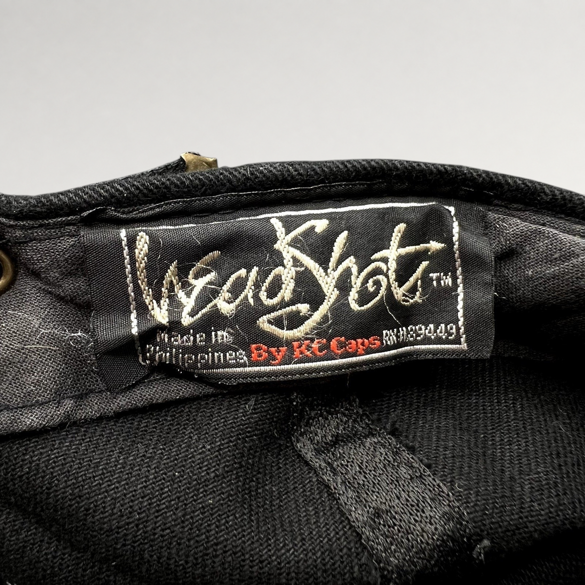 Raree Finds vintage 1990s KC Caps HeadShots label inside a black cotton Sandeman Port wine promotional hat