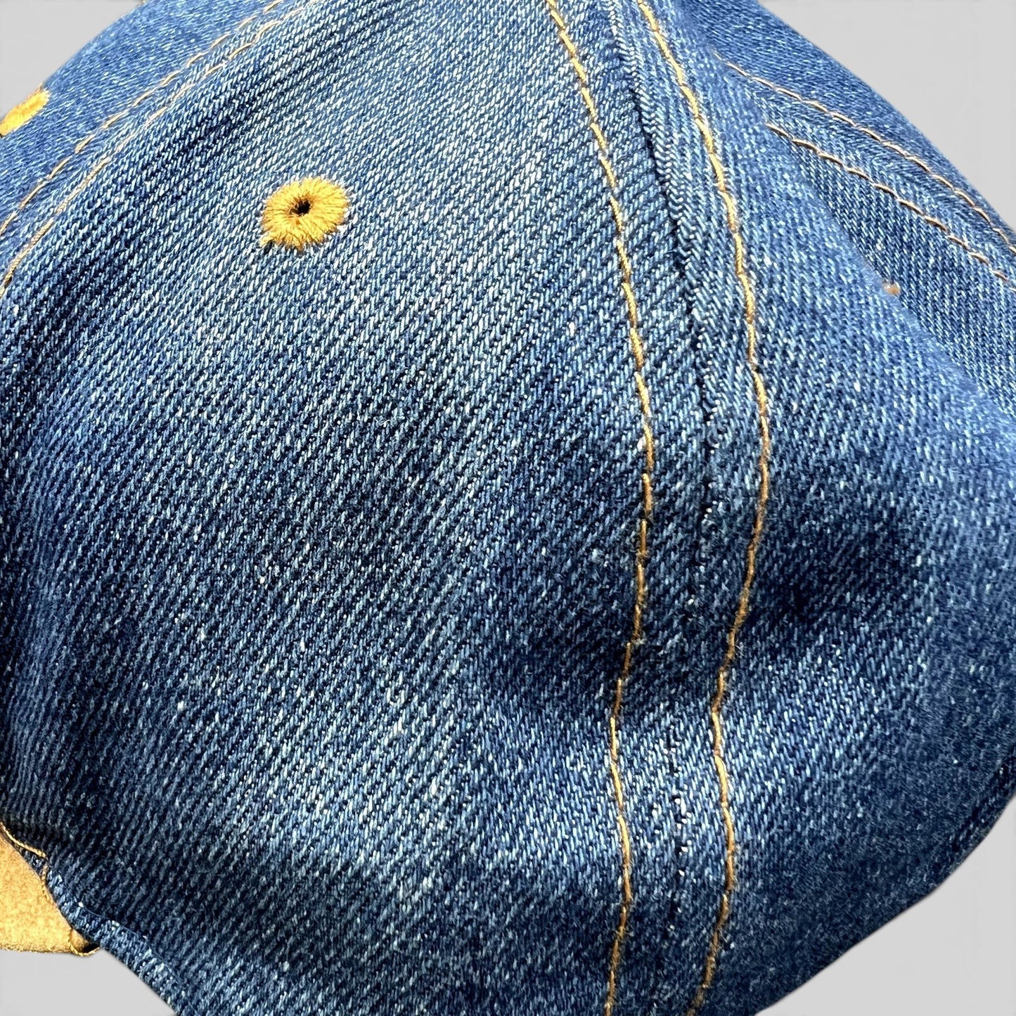Raree Finds vintage Nestlé Otto Cap featuring distressed indigo denim with golden stitching and tan suede brim detail.
