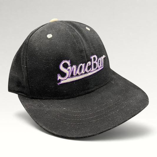 Raree Finds vintage 90s black snapback hat with purple SnacBar script embroidery and a structured front panel.