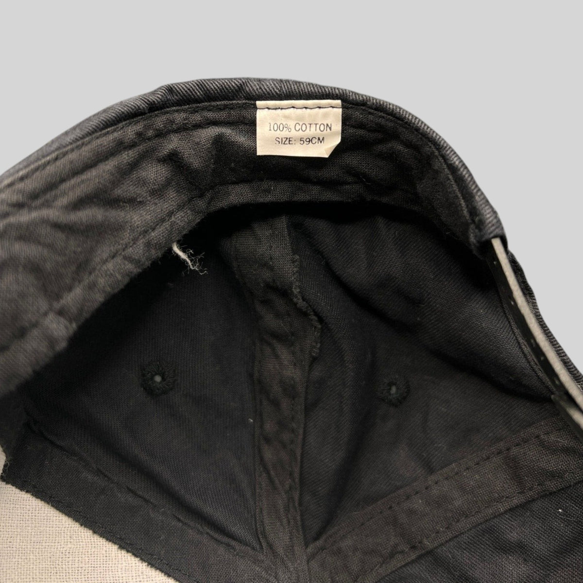 Raree Finds vintage 1990s black cotton snapback hat interior showing 100% cotton size 59cm label