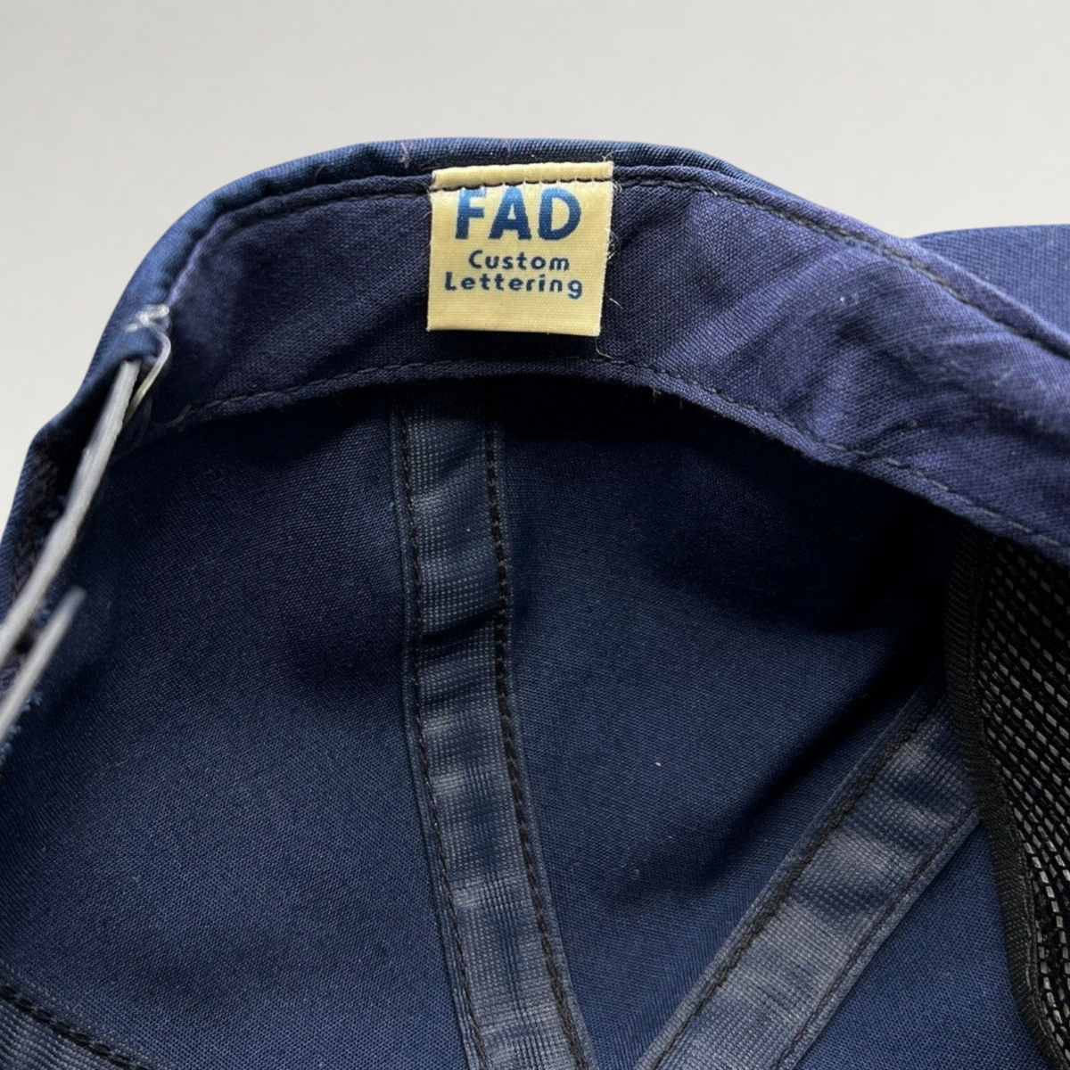 Raree Finds vintage navy blue cotton twill snapback hat interior showing FAD Custom Lettering brand tag