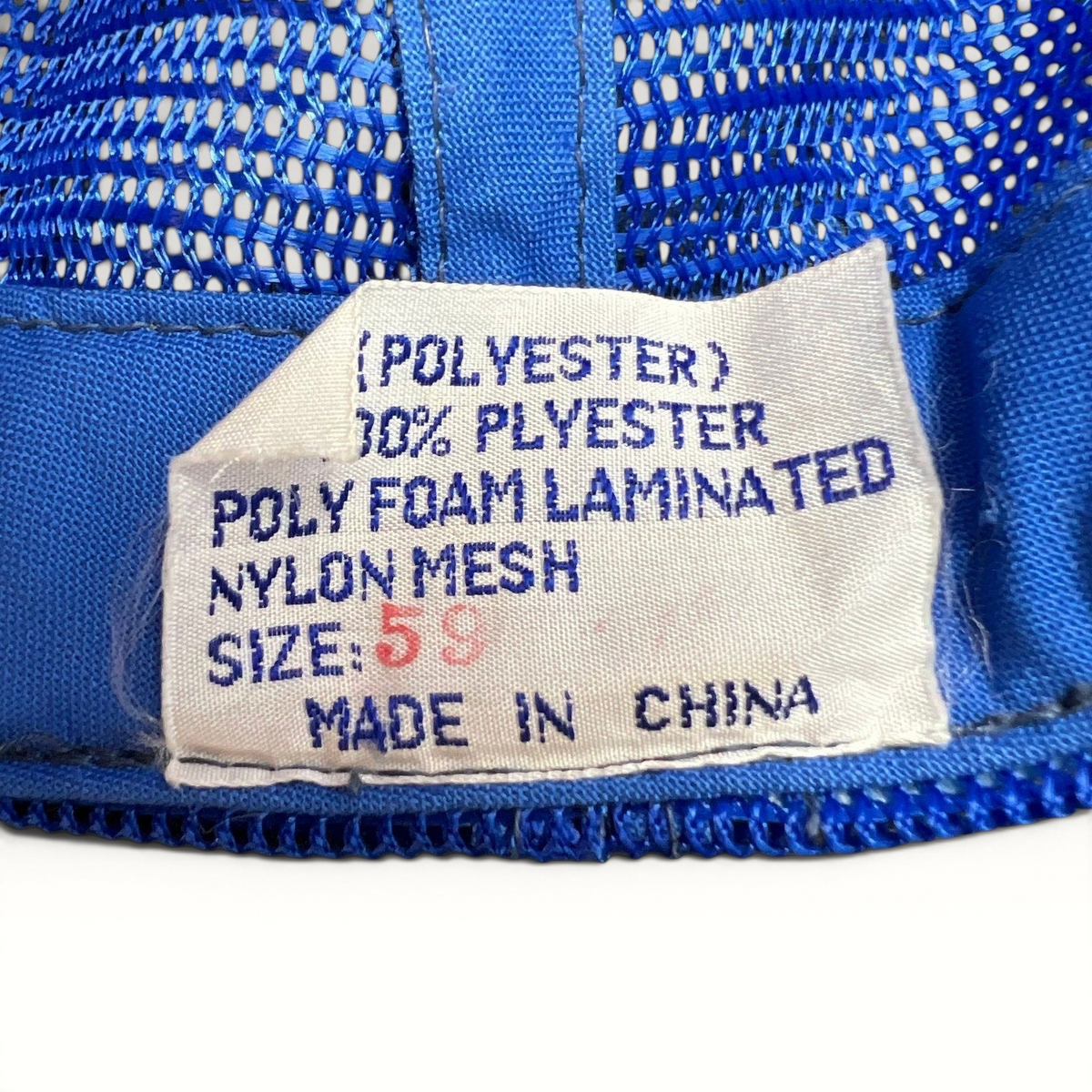Raree Finds vintage trucker hat interior care label showing polyester and nylon mesh material composition