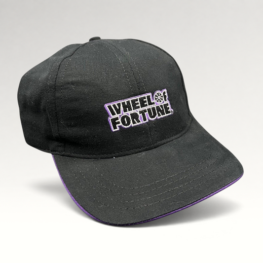 Raree Finds vintage Wheel of Fortune snapback hat in black cotton with purple brim trim and embroidered show logo.