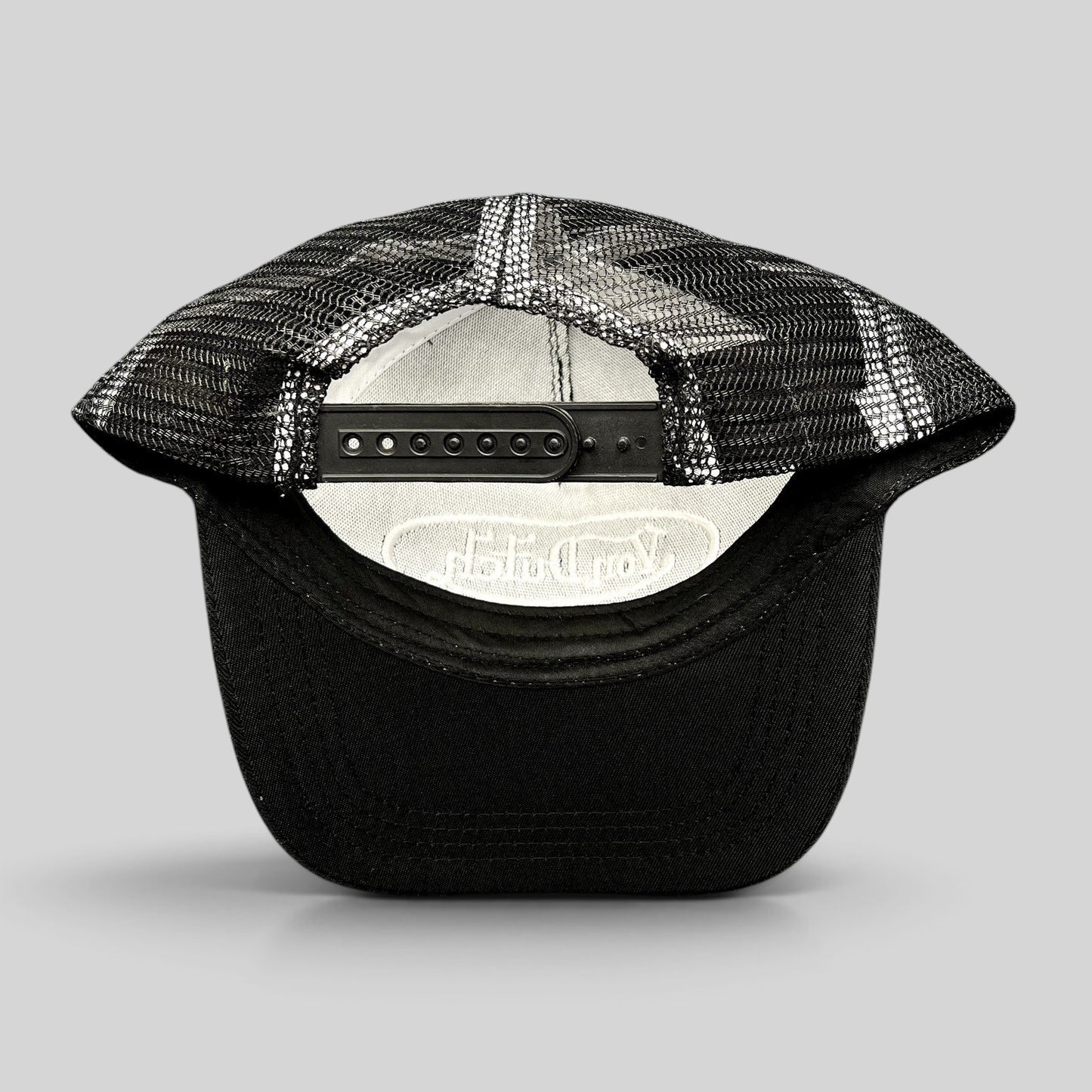 Raree Finds vintage Von Dutch black and white trucker hat showing the adjustable snapback closure and mesh back panel