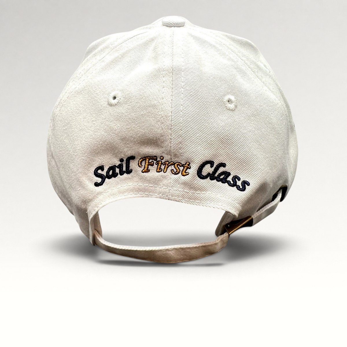 Raree Finds white cotton strapback cap with Sail First Class embroidery on the back and brass buckle closure