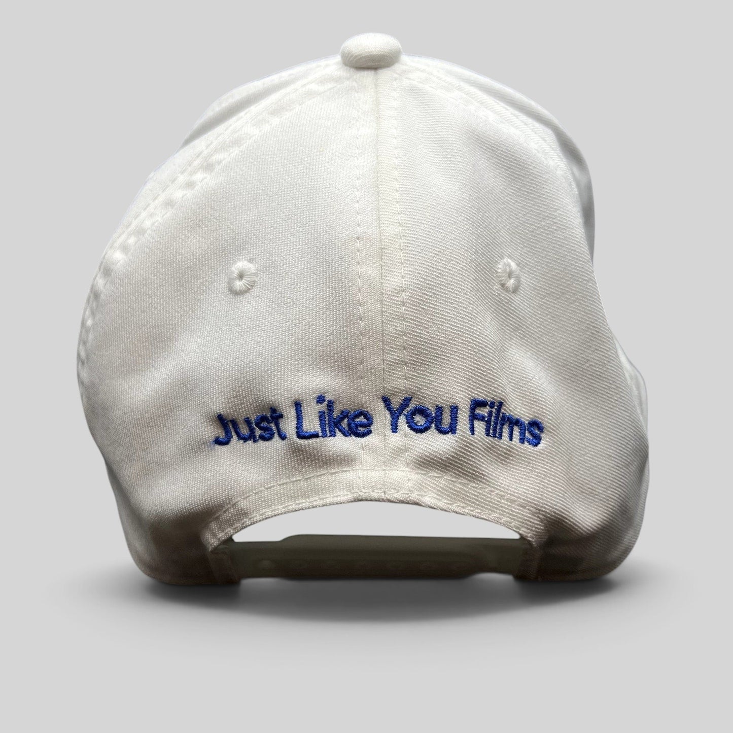 Raree Finds white Flexfit NU snapback hat with Just Like You Films embroidered in royal blue on the back