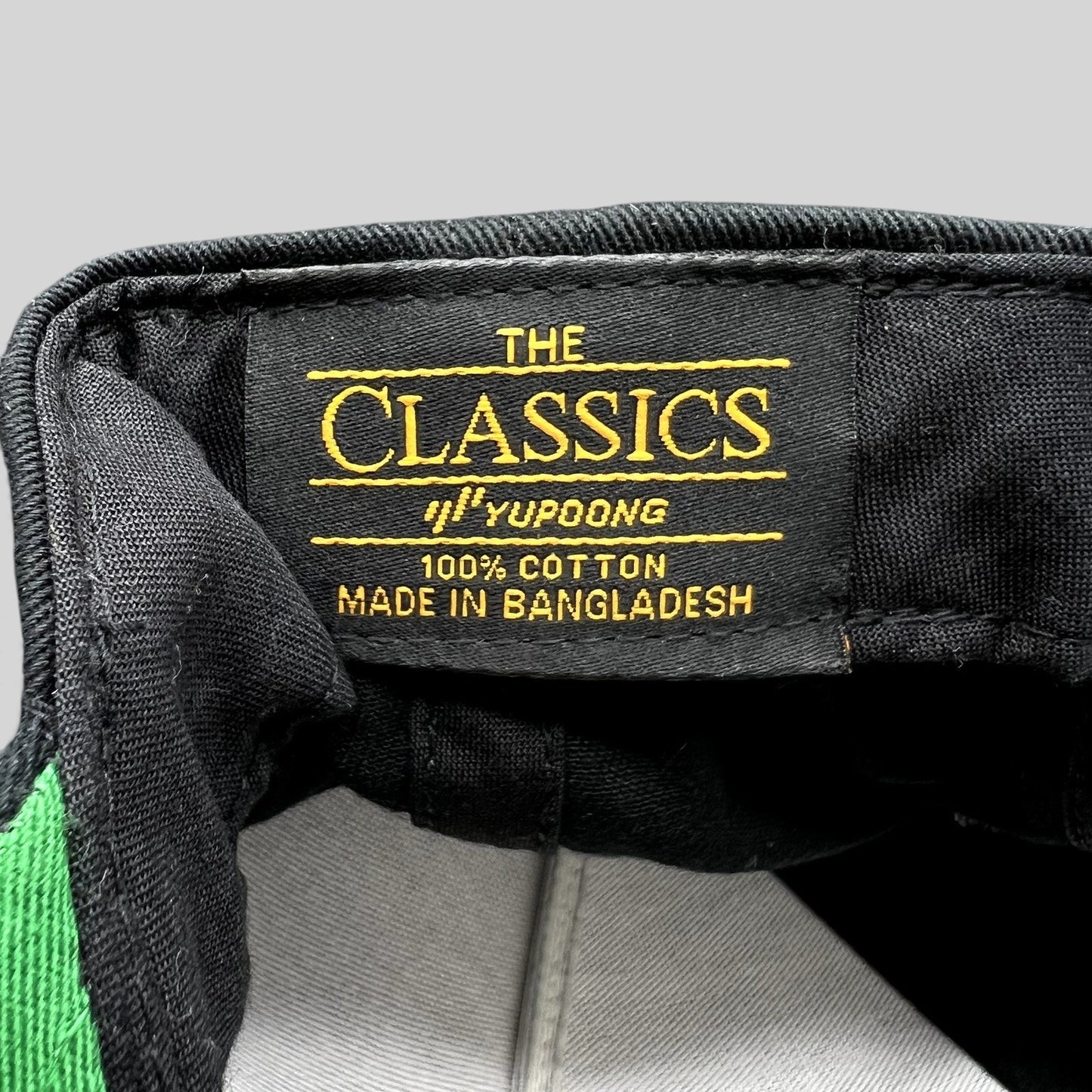 Raree Finds USC Trojans snapback interior label showing The Classics Yupoong branding and 100% cotton material tag